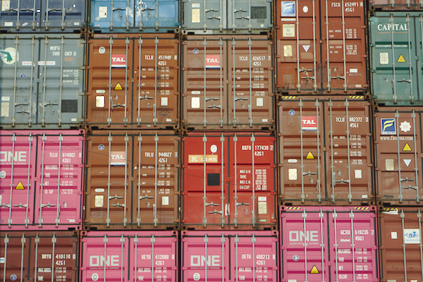 ship containers in different colours piled on top of each other