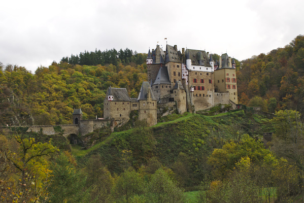 castle surrounded by trees in autumn colors