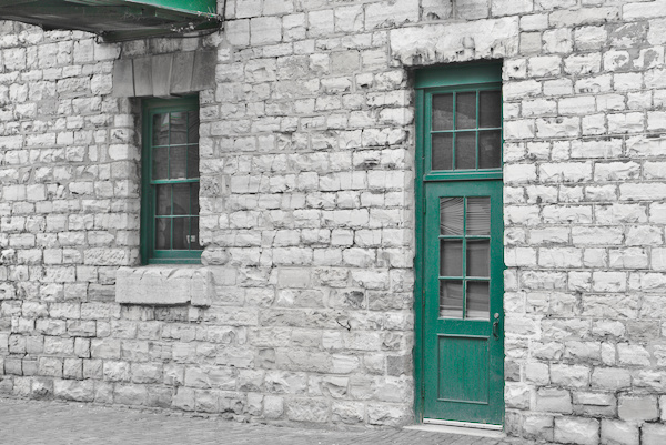 green door and green Window on a grey wall