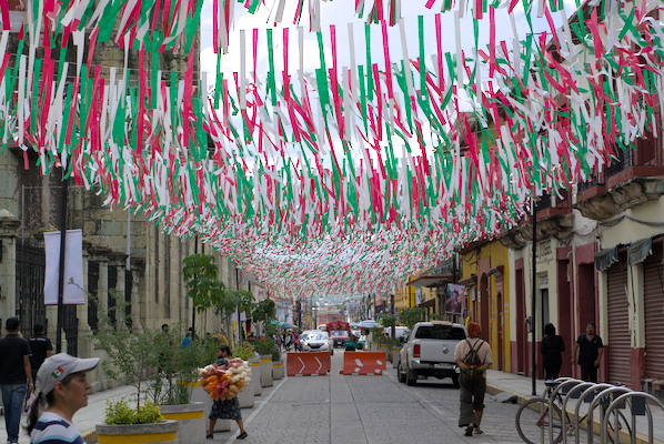 street with people and decoration in green, white, and red