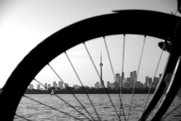 skyline of Toronto behind the wheel of a bike