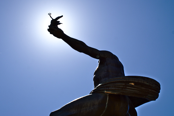 statue with Nike in his hand towards the sun