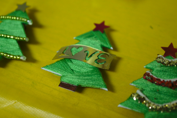 magnets in the form of Christmas trees, one with a golden label 'love'