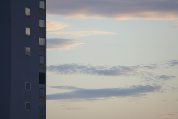 edge of a building and clouds in the light of sunset