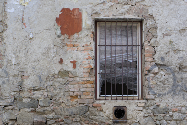 window with bars in a brick wall