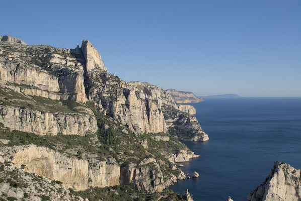 mountain ridge above blue water