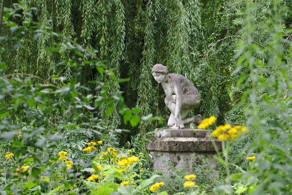 statue in a nymph with trees around