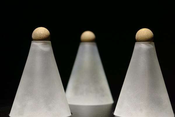 three glass cones with black background
