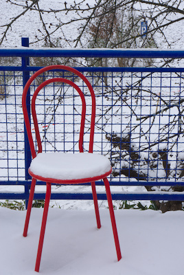 red chair and blue railing with snow